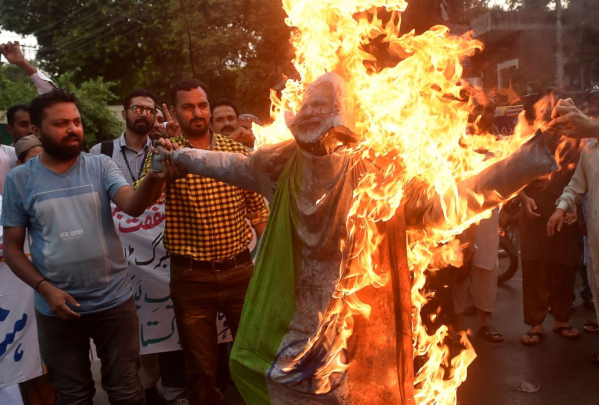 Protesters burn an effigy of Indian prime minister Narendra Modi during a protest in Lahore on 16 August 2019. Photo: AFP