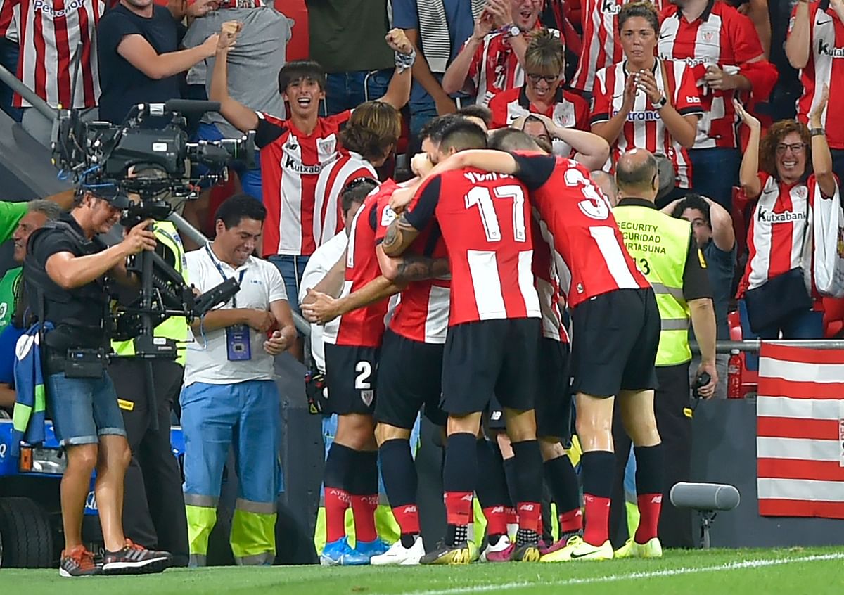 Athletic de Bilbao players celebrate Spanish forward Aritz Aduriz` goal during the Spanish league football match between Athletic Club Bilbao and FC Barcelona at the San Mames stadium in Bilbao on Friday. Photo: AFP