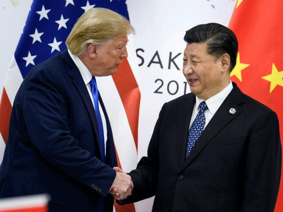 In this file photo taken on 29 June 2019 China`s president Xi Jinping (R) shakes hands with US president Donald Trump before a bilateral meeting on the sidelines of the G20 Summit in Osaka. Photo: AFP