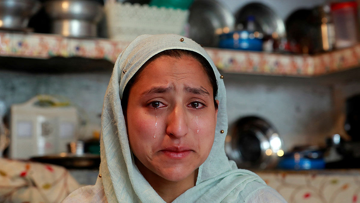A woman weeps inside her house after her household goods were allegedly damaged by Indian security forces following clashes between protesters and the security forces on Friday evening, during restrictions after the scrapping of the special constitutional status for Kashmir by the government, in Srinagar on 17 August. Photo: Reuters