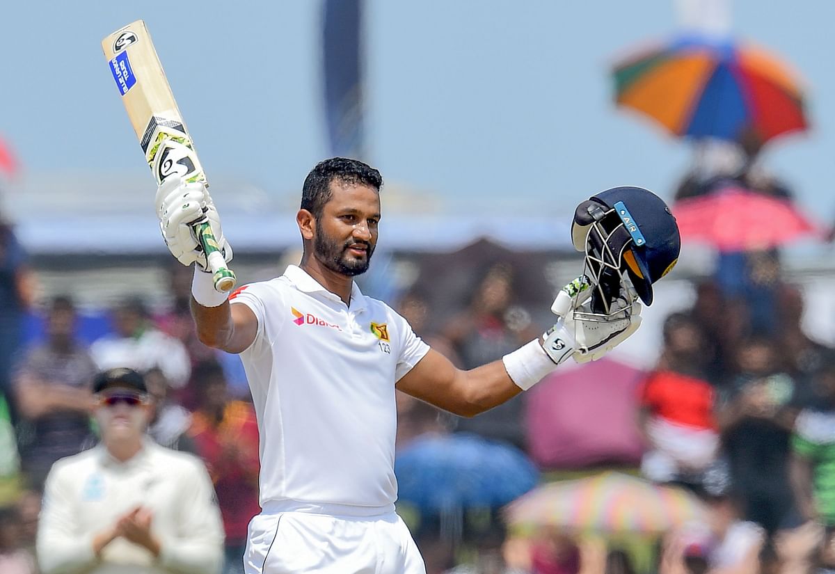 Sri Lanka`s cricket team captain Dimuth Karunaratne celebrates after scoring a century (100 runs) during the final day of the opening Test cricket match between Sri Lanka and New Zealand at the Galle International Cricket Stadium in Galle on 18 August. Photo: AFP