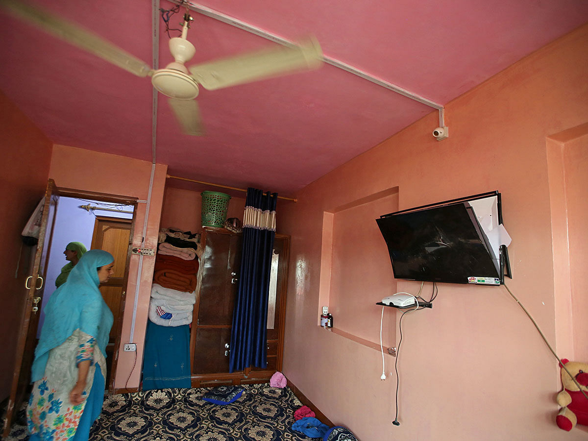 A woman stands next to a broken TV inside her house that was allegedly damaged by Indian security forces after clashes between protesters and the security forces on Friday evening, during restrictions after the scrapping of the special constitutional status for Kashmir by the Indian government, in Srinagar, on 17 August 2019. Photo: Reuters
