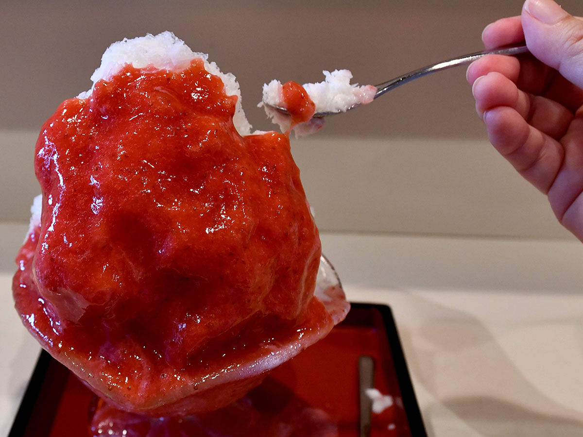 This picture taken on 21 June 2019 shows shop owner Koji Morinishi making a kakigori dessert with natural ice in the Yanaka district of Tokyo. Photo: AFP