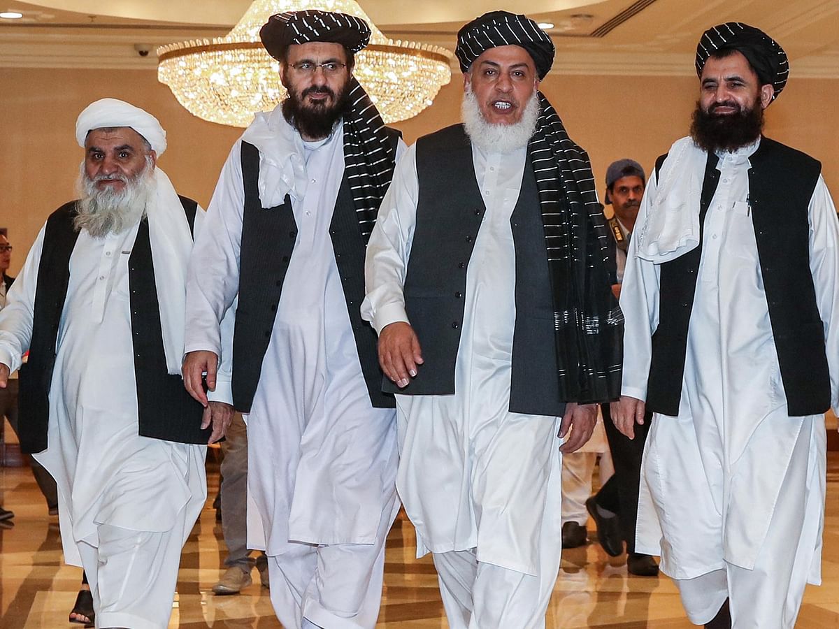 In this file photo taken on 8 July Mohammad Nabi Omari (C-L), a Taliban member formerly held by the US at Guantanamo Bay and reportedly released in 2014 in a prisoner exchange, Taliban negotiator Abbas Stanikzai (C-R), and former Taliban intelligence deputy Mawlawi Abdul Haq Wasiq (R) walk with another Taliban member during the second day of the Intra Afghan Dialogue talks in the Qatari capital Doha. Photo: AFP