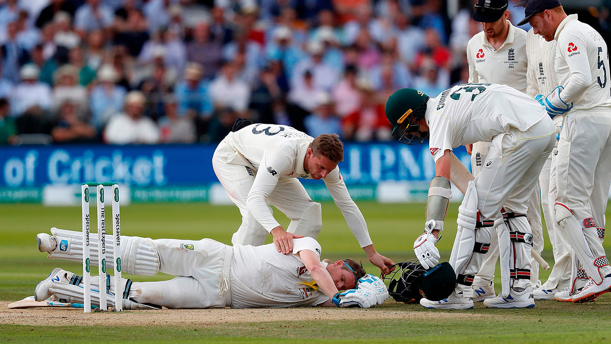 In this file photo taken on 17 August 2019 Australia`s Steve Smith lays on the pitch after being hit in the head by a ball off the bowling of England`s Jofra Archer (unseen) during play on the fourth day of the second Ashes cricket Test at Lord`s Cricket Ground in London. Photo: AFP