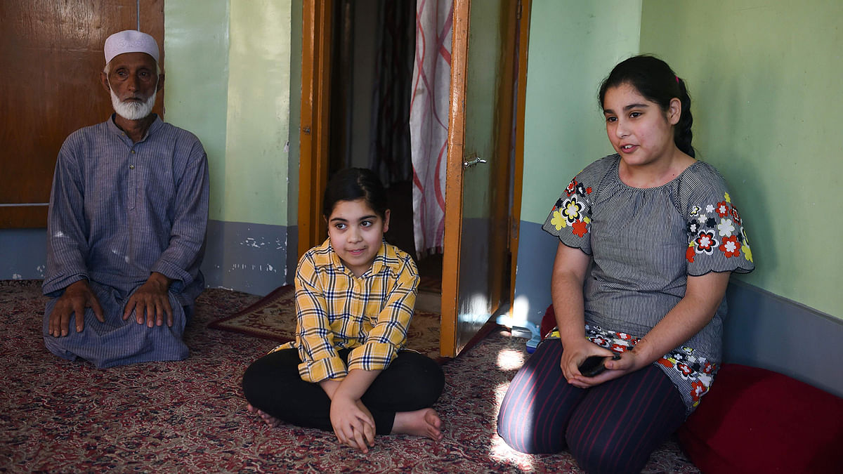 In this picture taken on 19 August 2019 13-year-old Habila (R) speaks with AFP during an interview in her home in Srinagar, where her father Showkat Shafi says she must stay instead of going to school until tensions in the region subside. Photo: AFP