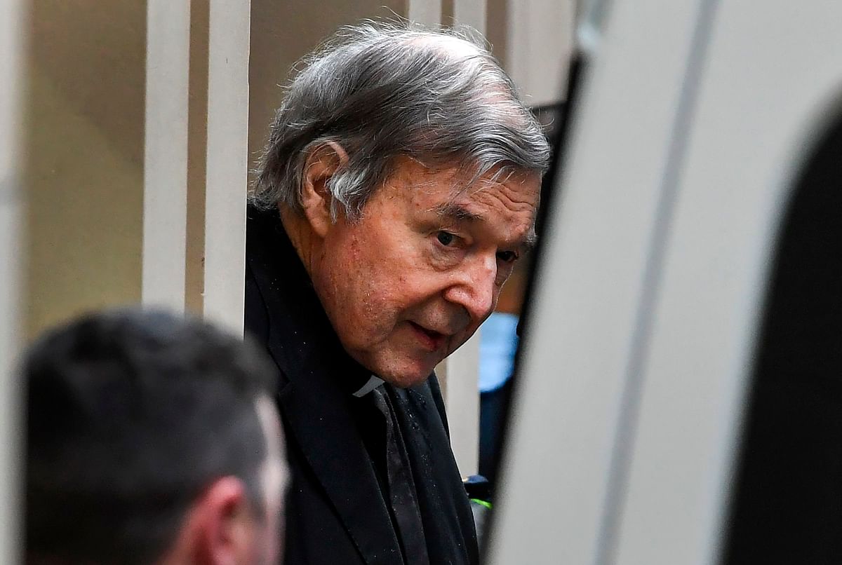 Australian Cardinal George Pell (C) is escorted in handcuffs from the Supreme Court of Victoria in Melbourne on 21 August 2019. Photo: AFP