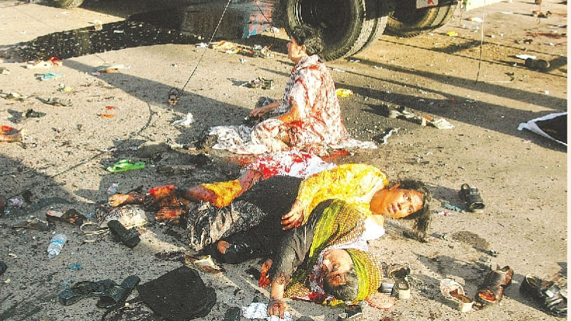 A while after the grenade attack. Ivy Rahman, sitting on the ground, was still alive then. File photo