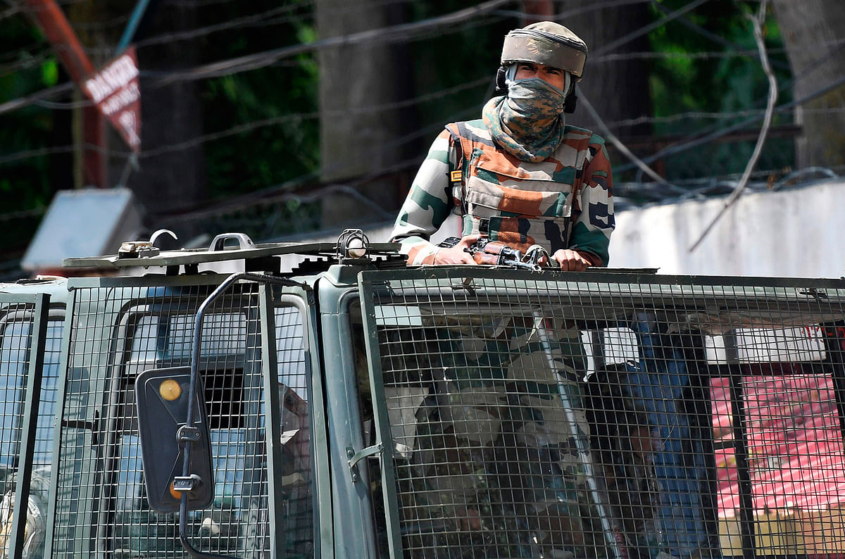 In this file photo taken on 18 August, 2019, an Indian army soldier stands alert in a truck while travelling in a convoy in Srinagar. Photo: AFP