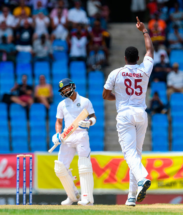 Shannon Gabriel (L) of West Indies celebrates the dismissal of Virat Kohli (L) of India during day 1 of the 1st Test between West Indies and India at Vivian Richards Cricket Stadium in North Sound, Antigua and Barbuda, on 22 August, 2019. Photo: AFP