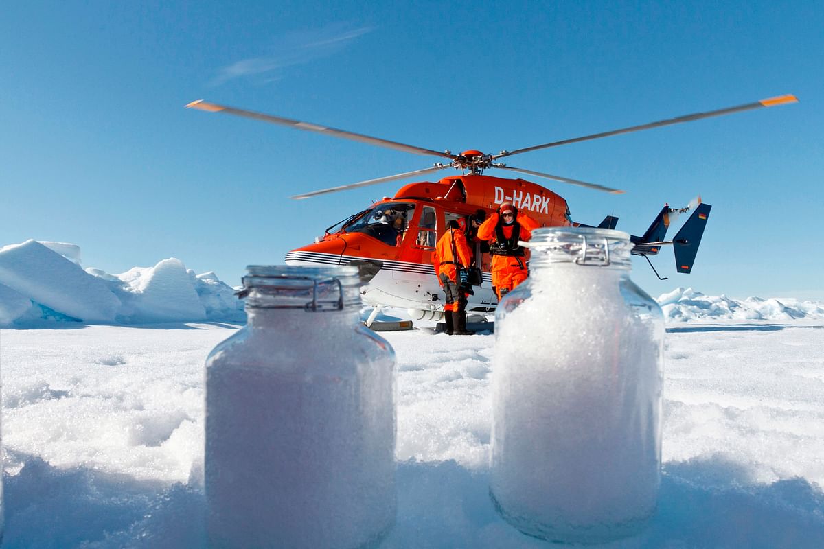 In this 4 August 2017, image courtesy of the Alfred Wegener Institute, scientists from the institute use the helicopter from the icebreaker research vessel Polarstern to collect snow samples in the Arctic. Minute microplastic particles have been detected in the Arctic and the Alps, carried by the wind and later washed out in the snow, according to a study that called for urgent research to assess the health risks of inhalation. Photo: AFP
