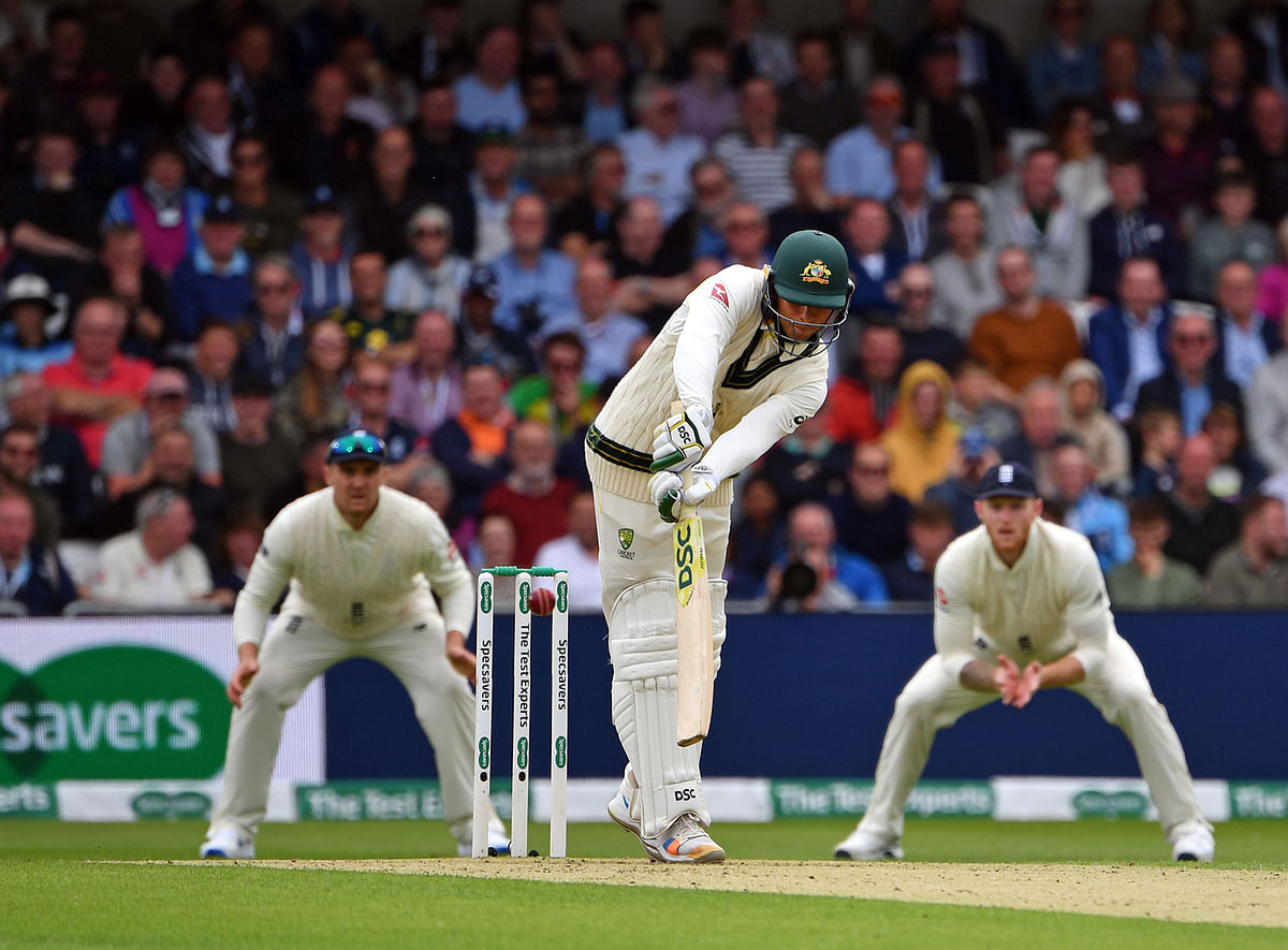 Australia`s Usman Khawaja (C) plays a shot to lose his wicket caught by England`s Jonny Bairstow (unseen) on the first day of the third Ashes cricket Test match between England and Australia at Headingley Stadium in Leeds, northern England, on 22 August, 2019. Photo: AFP