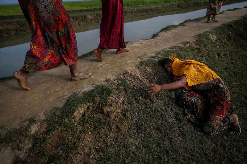 An exhausted Rohingya refugee fleeing violence in Myanmar cries for help from others crossing into Palang Khali, near Cox`s Bazar, Bangladesh on 2 November 2017. Reuters File Photo