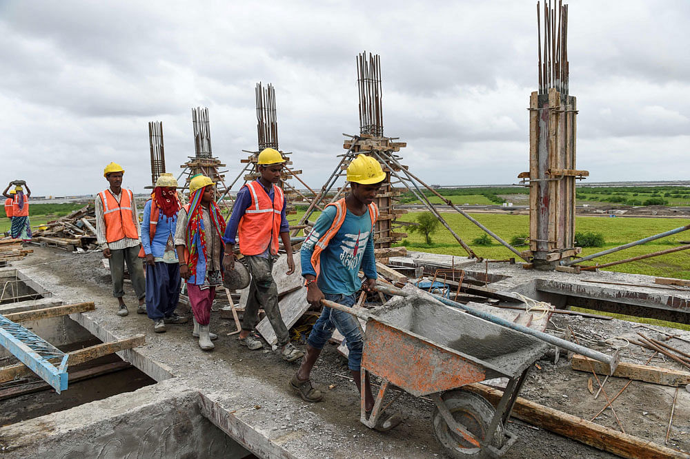 Labourers work at a construction site of the upcoming Dholera Industrial City, at Dholera some 110 kms from Ahmedabad on 16 August 2019. Photo: AFP