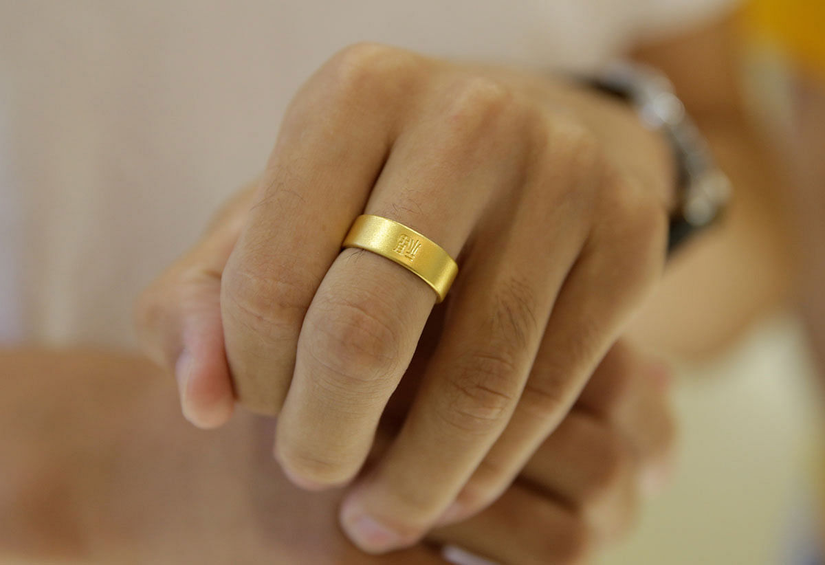 A gold ring is seen on the hand of a customer at Caibai Jewelry store, in Beijing, China, on 6 August 2019. Reuters File Photo