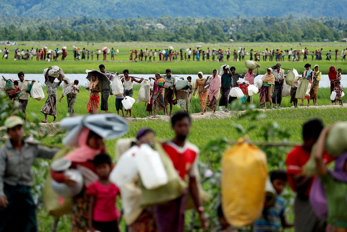 Rohingya refugees, who crossed the border from Myanmar two days before, walk after they received permission from the Bangladeshi army to continue on to the refugee camps, in Palang Khali, near Cox`s Bazar, Bangladesh on 19 October 2017. Reuters File Photo