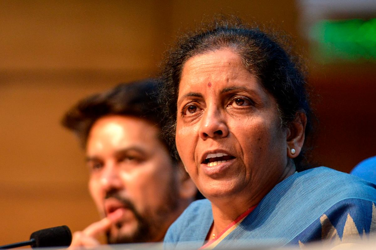 Union finance minister Nirmala Sitharaman (R) speaks as she attends a press conference along with Member of Parliament (MP) Anurag Thakur and finance secretary Rajiv Kumar in New Delhi on 23 August 2019. Photo: AFP