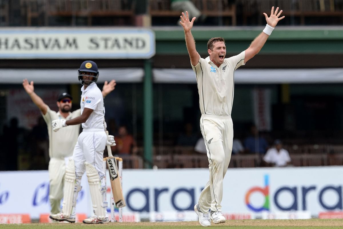 New Zealand’s cricketer Tim Southee ® celebrates after he dismissed Sri Lanka’s cricketer Lasith Embuldeniya © during the third day of the final cricket Test match between Sri Lanka and New Zealand at P. Sara Oval stadium in Colombo on Saturday. Photo: AFP