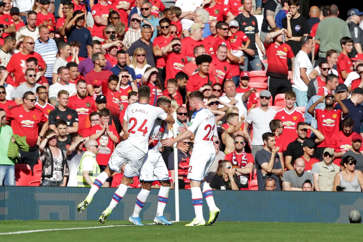 Crystal Palace`s Dutch defender Patrick van Aanholt (C) celebrates with teammates after scoring their late winning goal during the English Premier League football match between Manchester United and Crystal Palace at Old Trafford in Manchester, north west England, on 24 August 2019. Photo: AFP