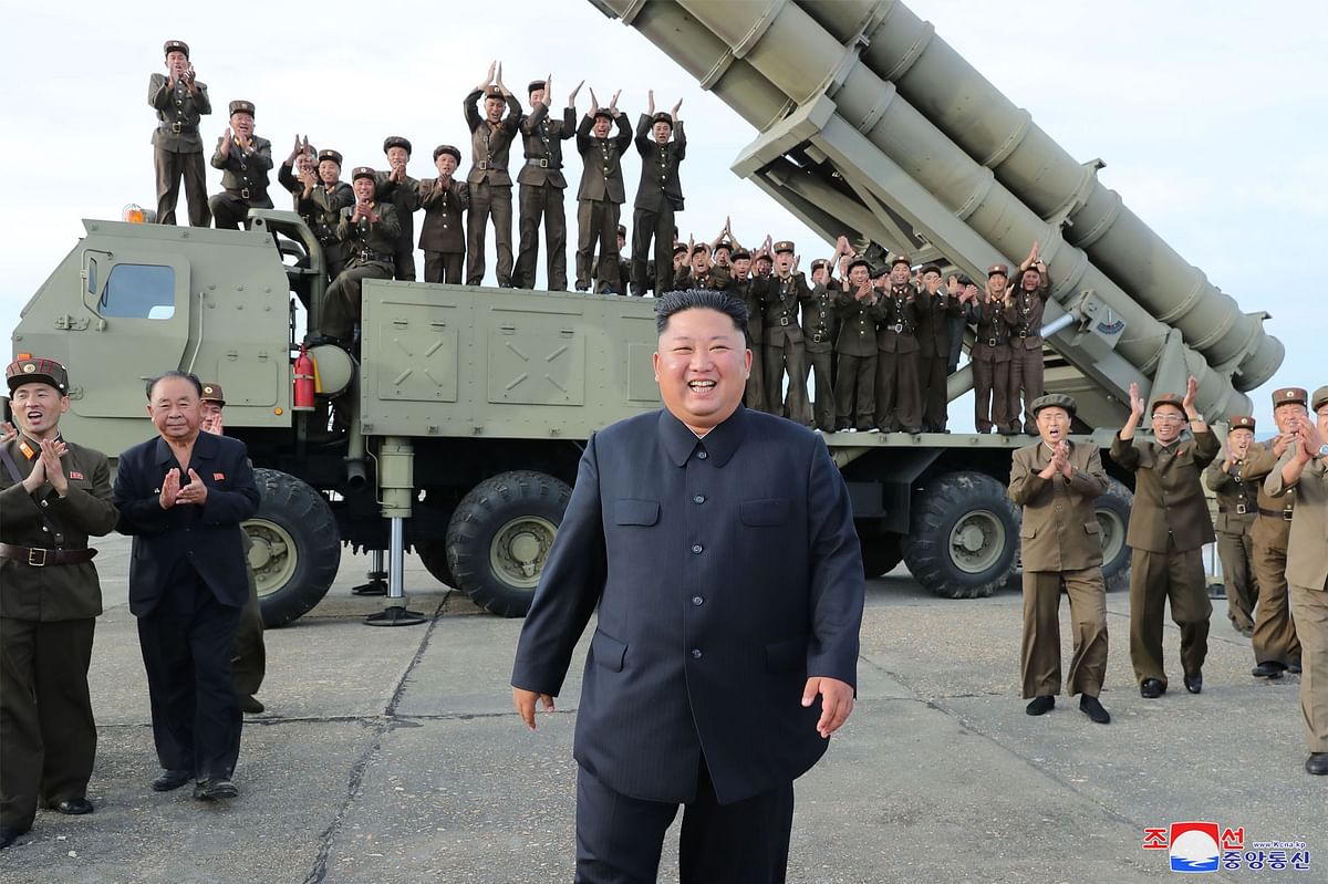 North Korean leader Kim Jong Un © celebrating the test-firing of a ‘newly developed super-large multiple rocket launcher’ at an undisclosed location on Friday. Photo: AFP