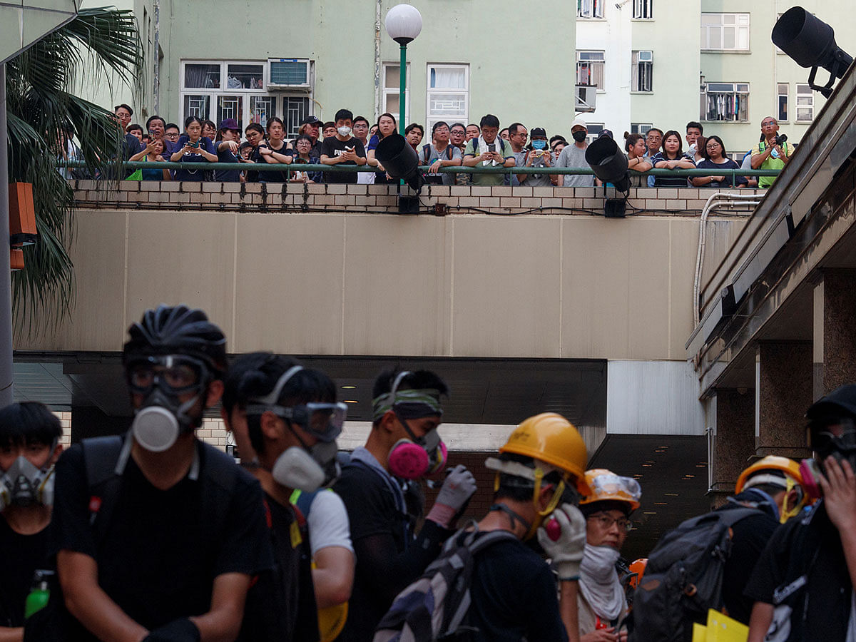 Locals watch protesters during a stand-off with police in Ngau Tau Kok in Hong Kong, China, on 24 August 2019. Photo: Reuters