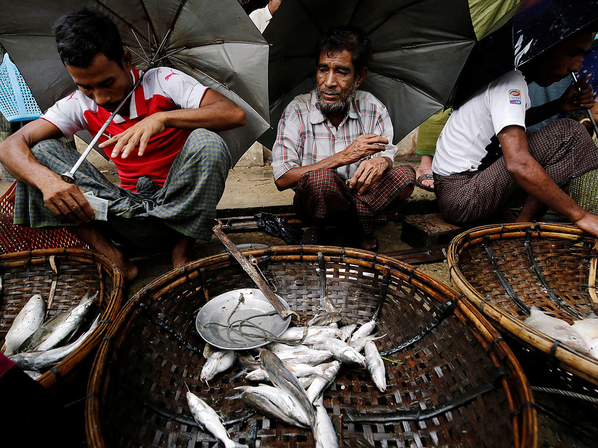 Muslim vendors sell fish in the market of Maungdaw, Rakhine on 9 July. Photo: Reuters