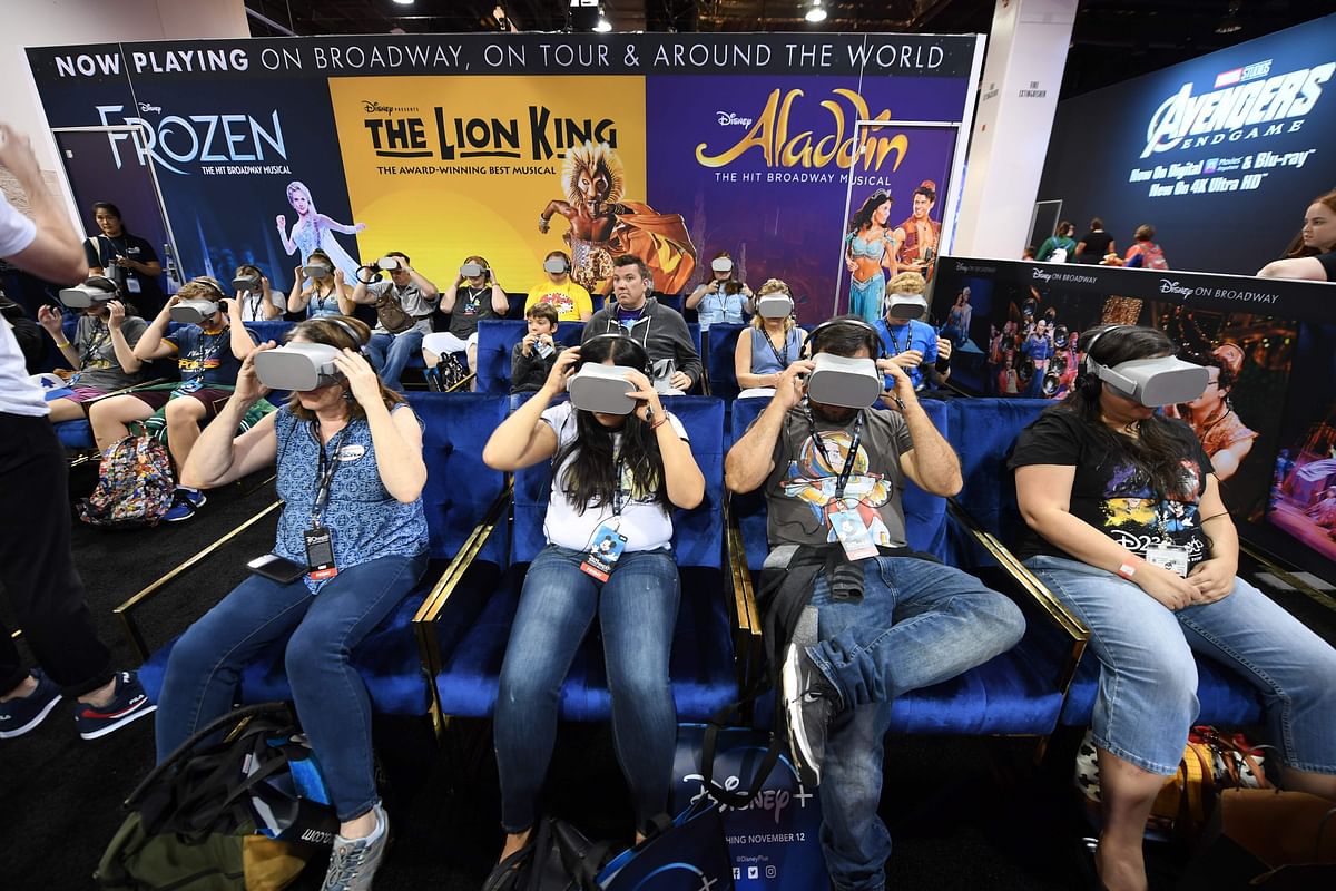 Attendee try the Disney on Broadway virtual reality experience at the D23 Expo, billed as the `largest Disney fan event in the world,` on 23 August at the Anaheim Convention Center in Anaheim, California. Photo: AFP