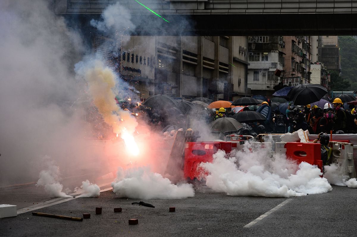 Police fire tear gas during a protest in Tsuen Wan district of Hong Kong on Sunday. Protesters gathered at a sports stadium as Hong Kong braced for more anti-government rallies, a day after clashes returned to the city`s streets following several days of relative calm. Photo: AFP
