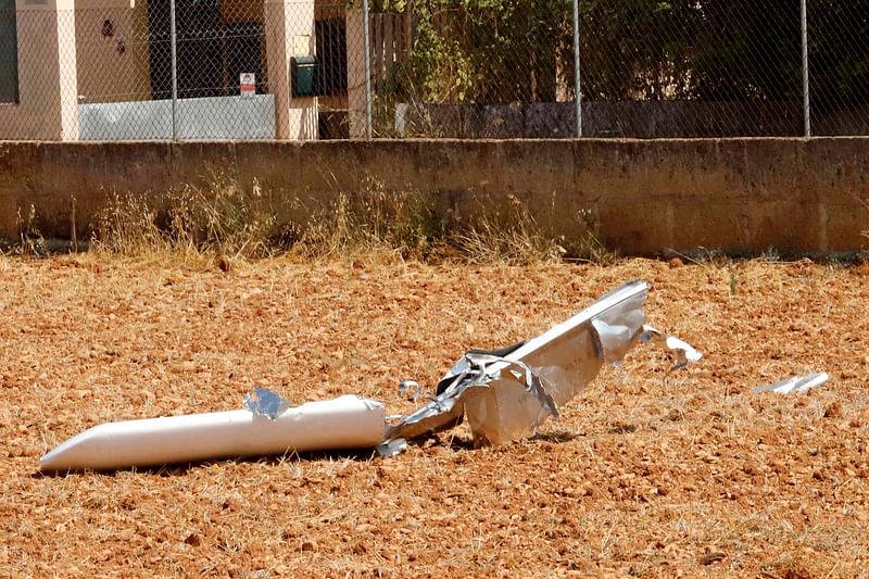 The wreckage of an aircraft is pictured on 25 August 2019 in a field in Inca, after seven people including two children were killed in a midair collision between a helicopter and a light aircraft over Spain`s Mallorca island. Photo: AFP