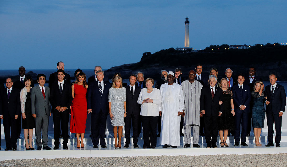 French president Emmanuel Macron, US president Donald Trump, Japan`s prime minister Shinzo Abe, Britain`s prime minister Boris Johnson, German chancellor Angela Merkel, Canada`s prime minister Justin Trudeau and Italy`s acting prime minister Giuseppe Conte pose for a family photo with invited guests during the G7 summit in Biarritz, France on 25 August. Photo: Reuters