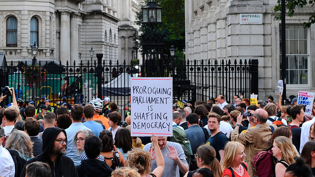 Anti-Brexit demonstrators hold placards as they protest outside of Downing Street in London on 28 August 2019. Photo: AFP