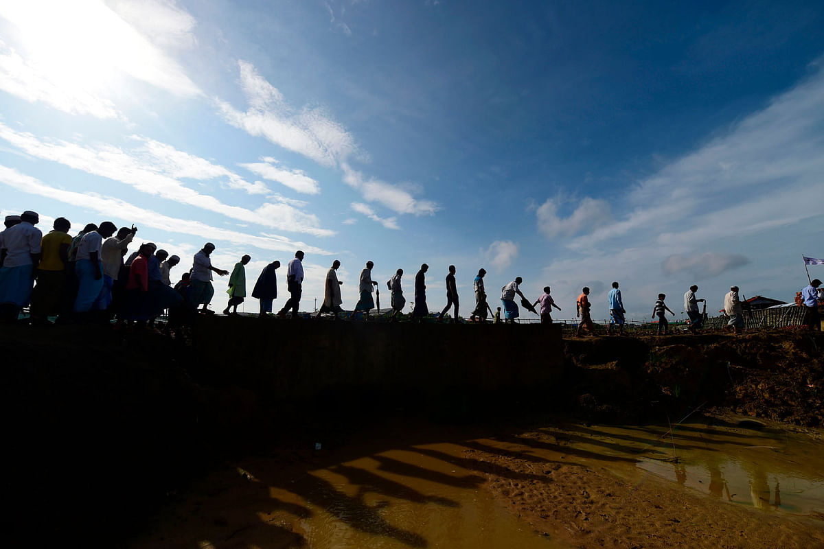 Rohingya refugees arrive to attend a ceremony organised to remember the second anniversary of a military crackdown that prompted a massive exodus of people from Myanmar to Bangladesh, at the Kutupalong refugee camp in Ukhia on 25 August 2019. Photo: AFP