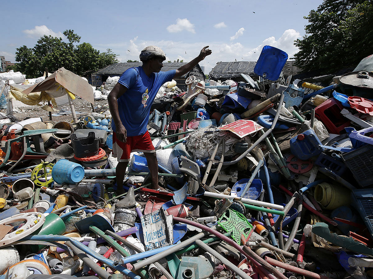 A man sorts plastic items at a junkyard in Kolkata, India, on 30 August 2019. Photo: Reuters