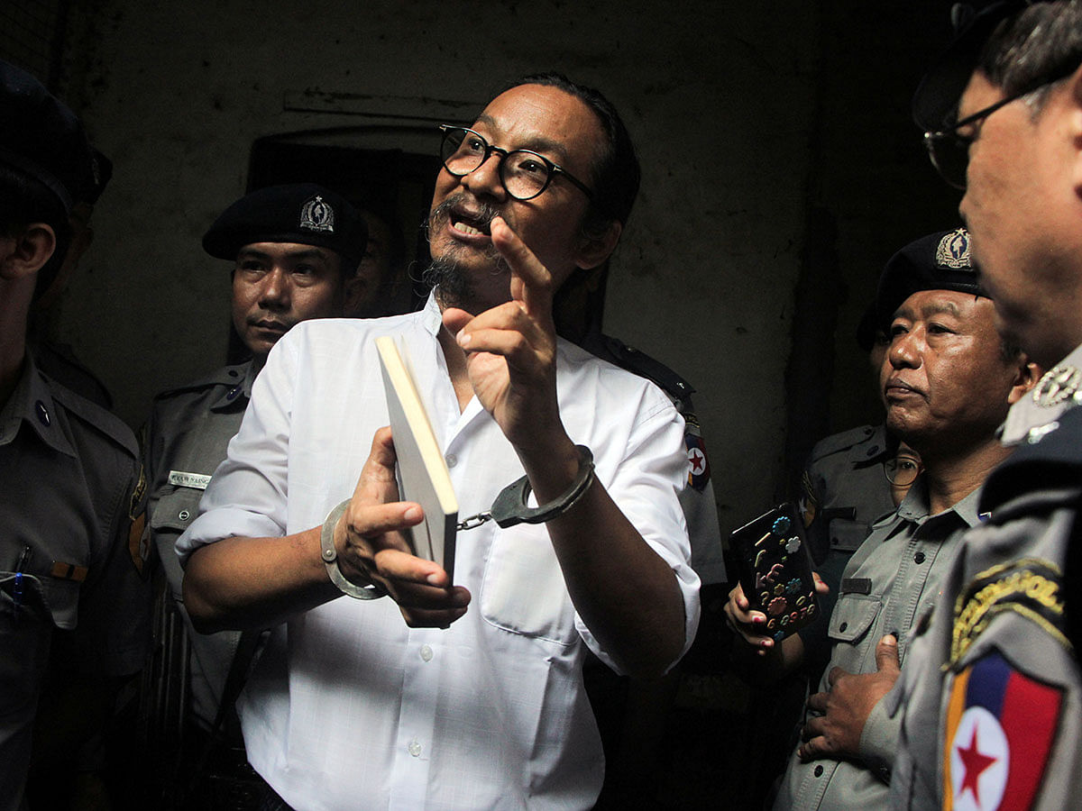 Filmmaker Min Htin Ko Ko Gyi is escorted out by police after a court hearing in Yangon, Myanmar, on 29 August 2019. Photo: Reuters