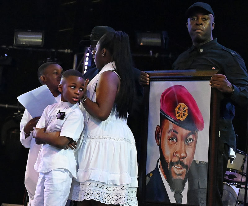 Children of late Ivorian singer DJ Arafat attend their father funerals at the Felix Houphouet-Boigny stadium in Abidjan, Ivory Coast on Friday. Photo: AFP