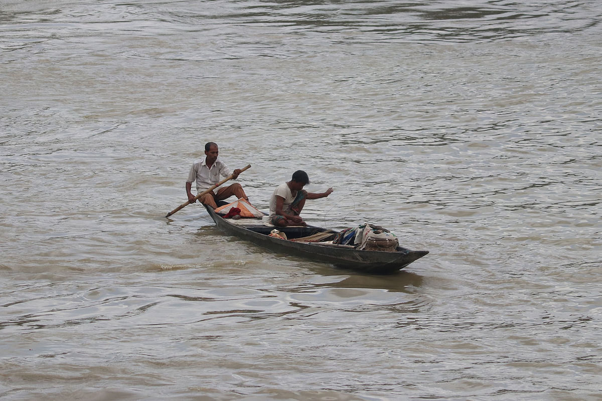 Two fishermen are busy catching fish in Surma River at Kumargaon area of Sylhet on 31 August. Photo: Anis Mahmud