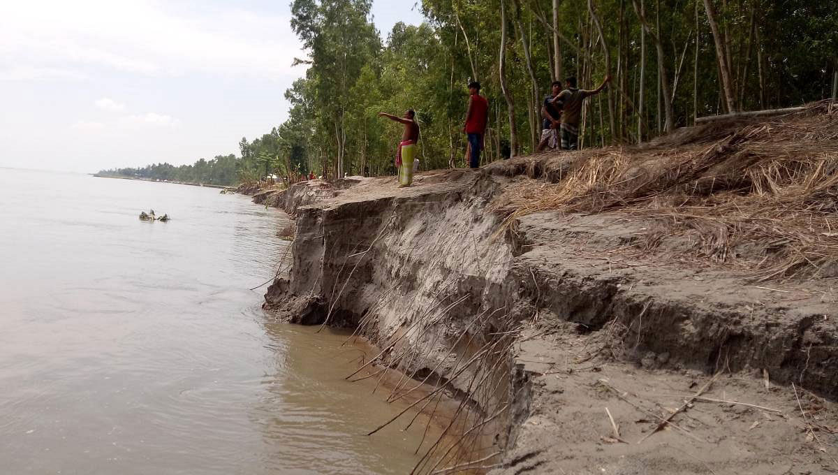 A man shows the location of his home before the erosion of Brahmaputra. Photo: UNB