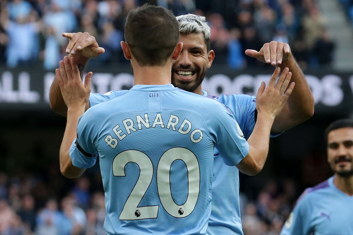Manchester City`s Portuguese midfielder Bernardo Silva (L) celebrates with Manchester City`s Argentinian striker Sergio Aguero (R) after scoring their fourth goal during the English Premier League football match between Manchester City and Brighton and Hove Albion at the Etihad Stadium in Manchester, north west England, on 31 August, 2019. Photo: AFP