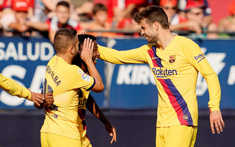 Barcelona’s Anssumane Fati celebrates scoring their first goal with team mates at El Sadar Stadium, Pamplona, Spain on Saturday. Photo: Reuters