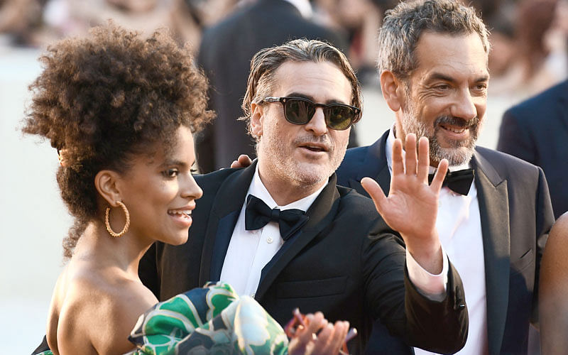 US actor Joaquin Phoenix signs poses for selfie photos for fans as he arrives for the screening of the film “Joker” on 31 August presented in competition during the 76th Venice Film Festival at Venice Lido. Photo:  AFP