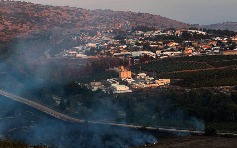 This picture taken on 1 September 2019 from a location near the southern Lebanese village of Maroun al-Ras, close to the border with Israel, shows smoke rising from fires along the border with Israel on the Lebanese side following an exchange of fire, with the northern Israeli town of Avivim in the background. Photo: AFP