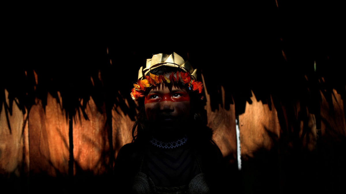 An Indigenous girl from the Shanenawa tribe poses for a photo during a festival to celebrate nature and ask for an end to the burning of the Amazon, in the indigenous village of Morada Nova near Feijo, Acre State, Brazil, on 1 September 2019. Photo: AFP