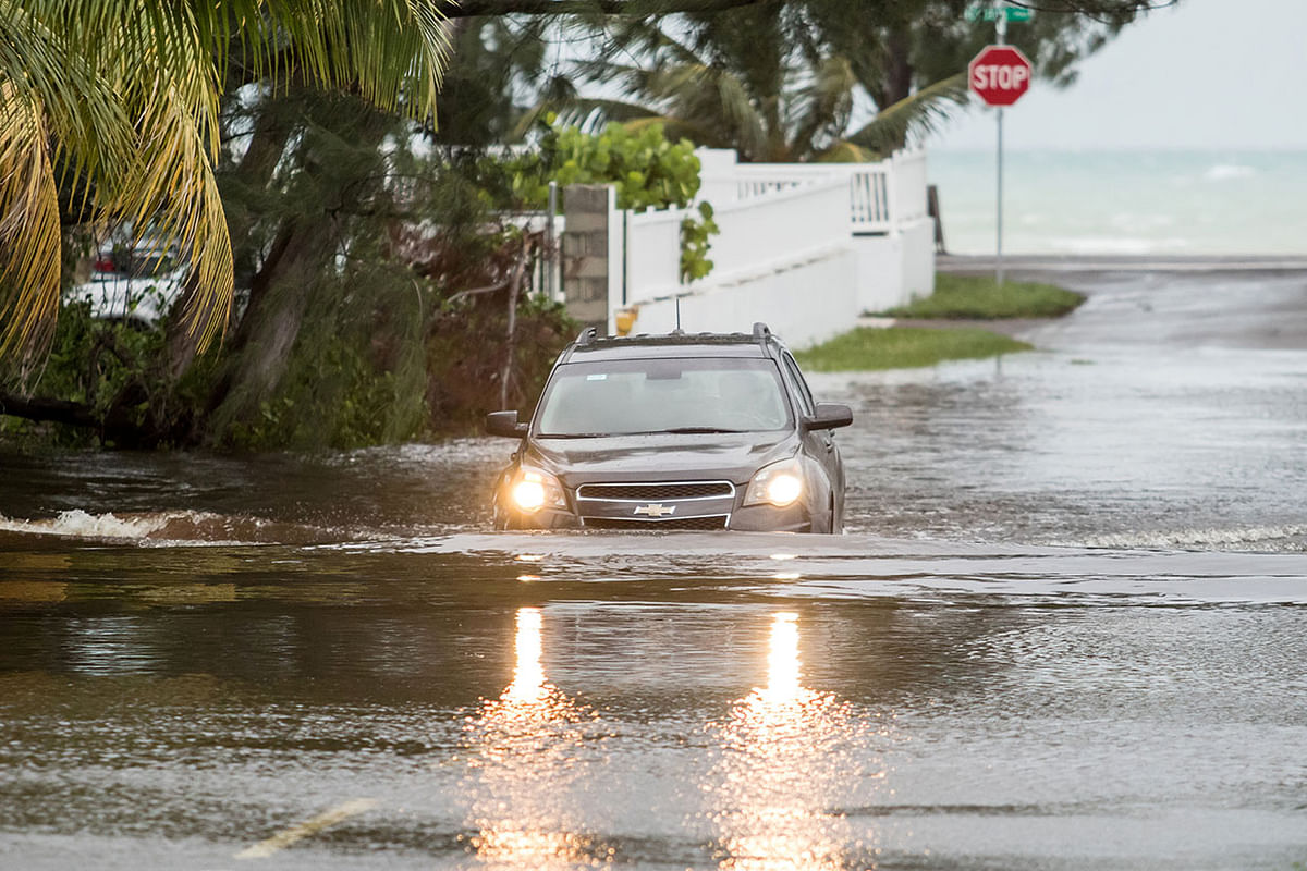 A car drives through a flooded street after the effects of Hurricane Dorian arrived in Nassau, Bahamas 2 September. Photo: Reuters