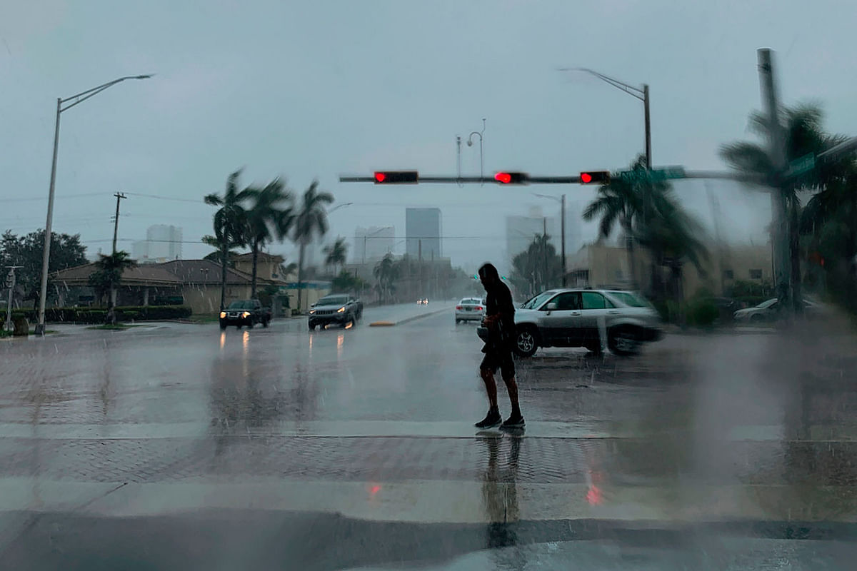 A man crosses the street during a pouring rain in Fort Lauderdale, Florida on 2 September. Photo: AFP
