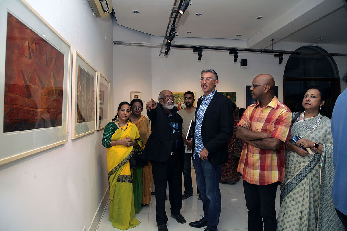 Visitors look at art at Alliance Francaise`s La Galerie in Dhaka on Monday. Photo: Prothom Alo.
