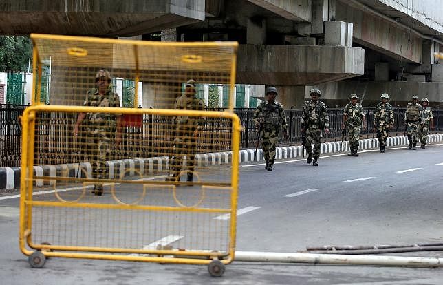 Indian security forces personnel patrol a deserted road during restrictions after the government scrapped special status for Kashmir, in Srinagar 7 August. Photo: AFP
