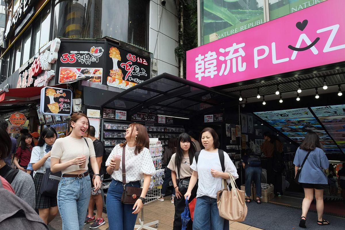 his picture taken on 27 August 2019 shows people walking along a street in the Shin-Okubo district, known as Tokyo`s Korean town lined with small shops, most of them selling Korean food and pop-culture items.Photo: AFP