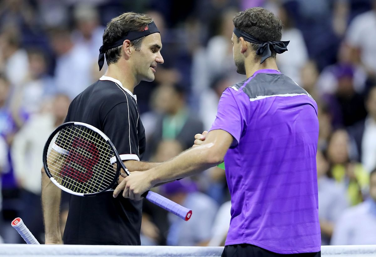 Roger Federer of Switzerland congratulates Grigor Dimitrov of Bulgaria on his win after their quarterfinal Men`s Singles match on day nine of the 2019 US Open at the USTA Billie Jean King National Tennis Centre on 3 September 2019 in Queens borough of New York City. Photo: AFP