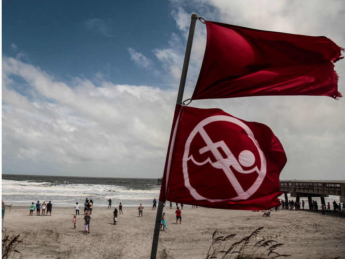 Red flags to indicate that the ocean has a high tide and locals should not be swimming due to danger are seen at Jacksonville Beach before Hurricane Dorian, in Jacksonville. Photo: AFP