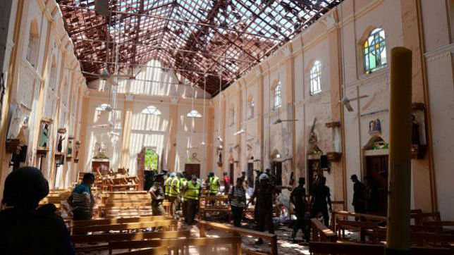 Crime scene officials inspect the site of a bomb blast inside a church in Negombo, Sri Lanka 21 April, 2019. Photo: Reuters